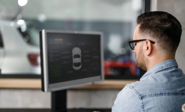 Man looking at monitor with details about a vehicle
