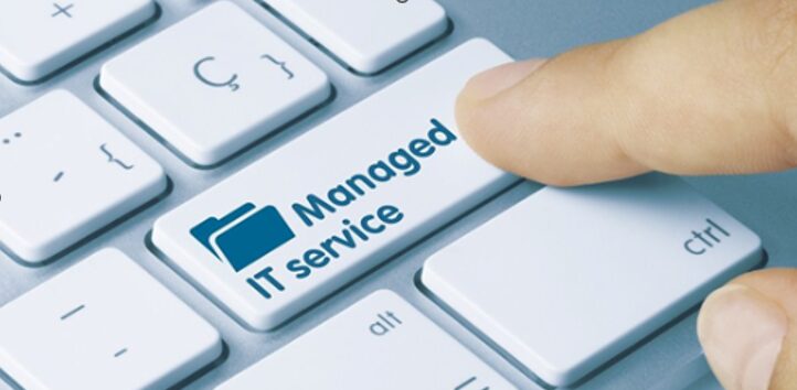 person about to click a button labeled as managed IT services