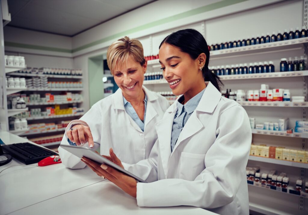 two pharmacist working together on a tablet